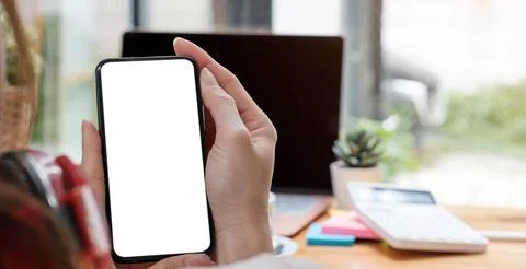 Mockup image blank white screen cell phone.women hand holding texting using.. Foto stock