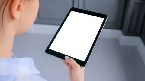 Mockup image of digital tablet computer with white blank screen in woman hands Stock Photos