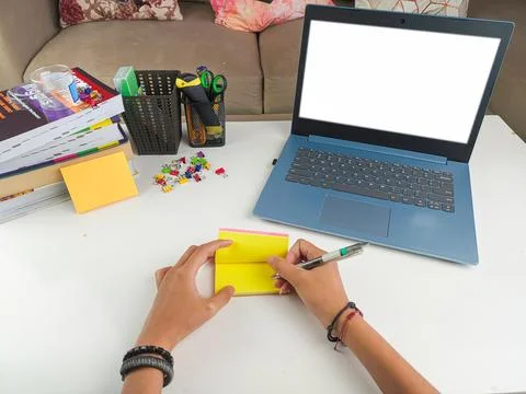 Mockup image, Laptop computer with blank screen with a woman taking notes Stock Photos