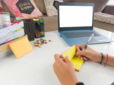 Mockup image, Laptop computer with blank screen with a woman taking notes Stock Photos