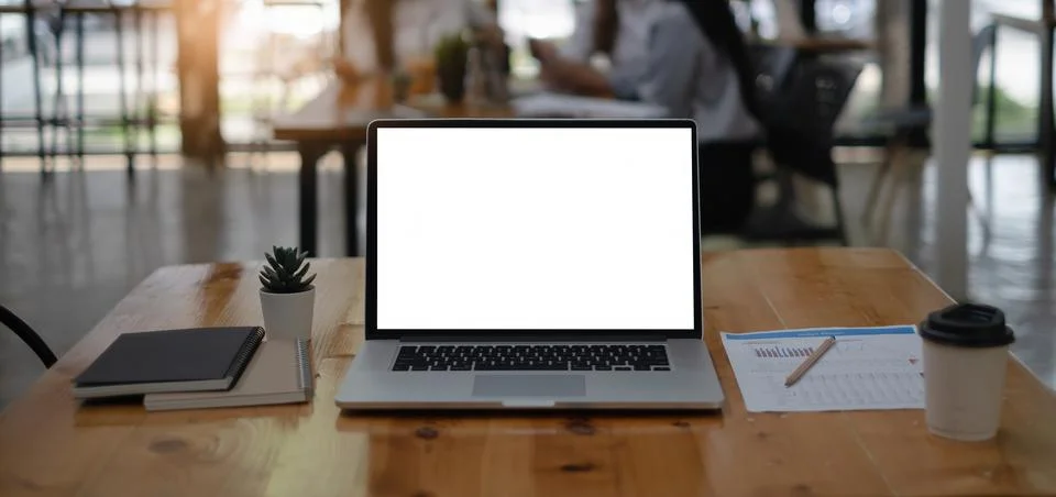 Mockup image of a laptop computer with white blank screen on wooden desk. Stock Photos
