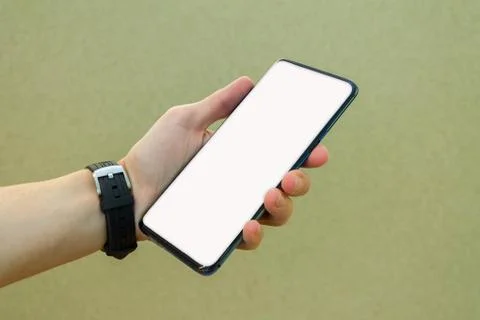 Mockup image of man hand holding modern black phone with thin edges Stock Photos