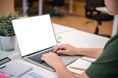 Mockup image of a woman's hand working on a laptop with blank white desktop.. Stock Photos