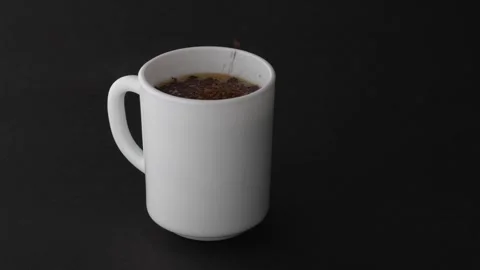 Mockup instant coffee granules falling into white cup black background 4K Видео 332128971