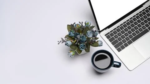 Mockup laptop computer with empty display, coffee cup and flower pot on white Stock Photos