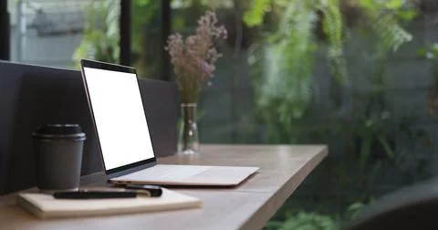Mockup laptop computer with empty display on wood table. Stock Photos