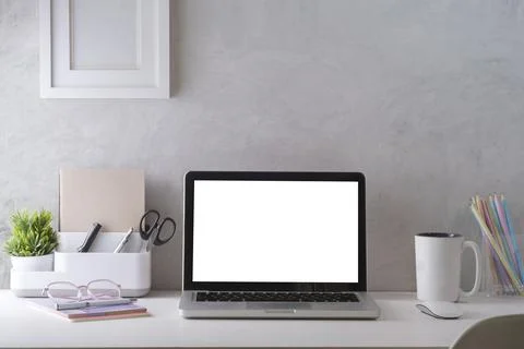 Mockup laptop with empty display, coffee cup, books and picture frame on whit Stock Photos