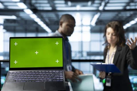 Mockup laptop in front of data center workers calibrating energy usage Stock Photos