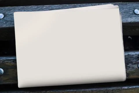 The MockUp of the newspaper on a bench. Stock Photos