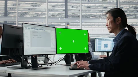 Mockup PC used by Asian man reviewing microchip production in factory Stock Footage 335880461