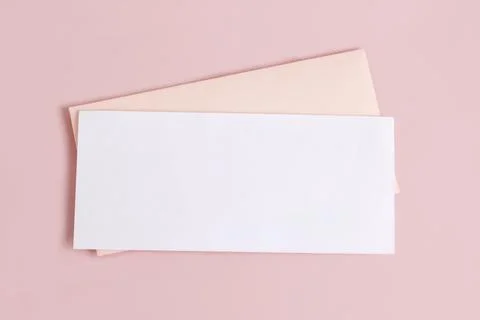 Mockup with a rectangular blank letterhead and an envelope on a pink backgrou Stock Photos
