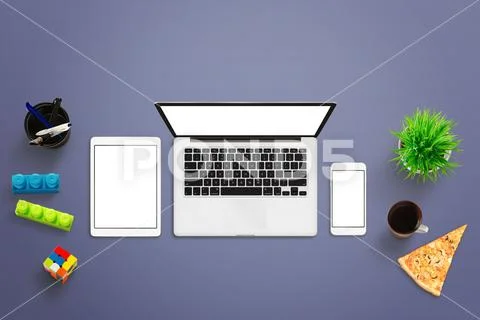 Mockup of responsive devices. Top view of desk with laptop computer, mobile p Stock Photos