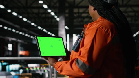 Mockup screen on tablet held by black woman in large-scale warehouse Stock Footage 330086909
