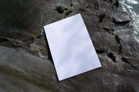 Mockup of sheet with shadow on stones in diffused sunlight Stock Photos