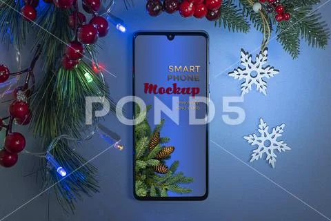 Mockup smartphone and two snowflakes for the Christmas tree on a blue backgro Modello PSD