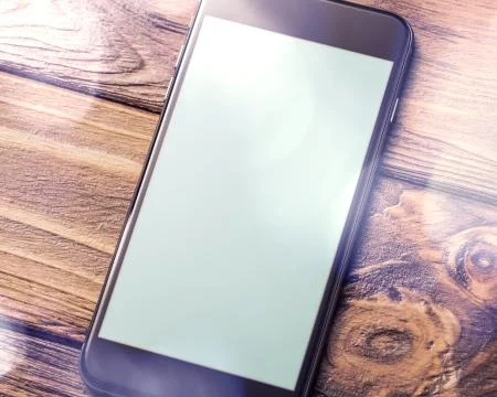 Mockup of smartphone laying on table 写真素材