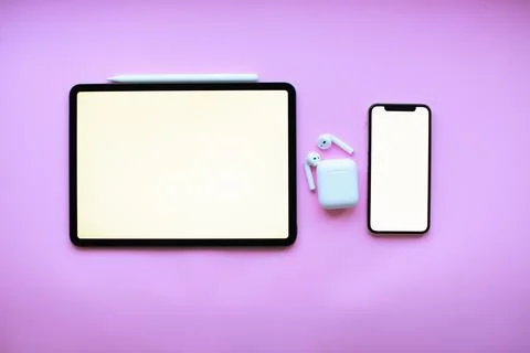 Mockup . Tablet ipad, iphone l and air pods on pink background Stock Photos
