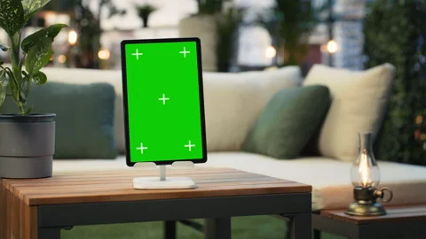 Mockup tablet with isolated screen next to potted plant on wooden rooftop table Stock Footage 345166172
