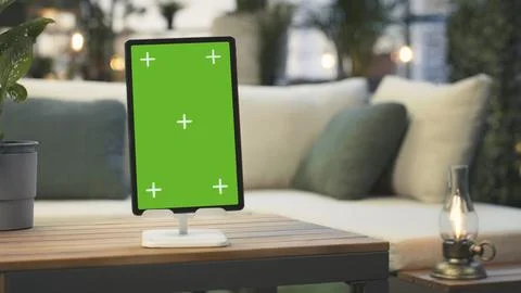 Mockup tablet with isolated screen next to potted plant on wooden rooftop table Stock Photos