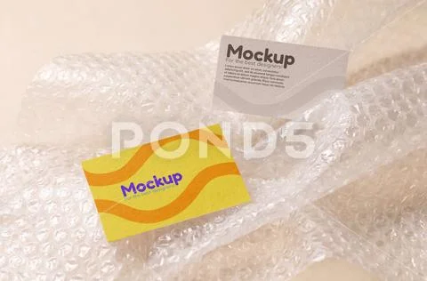 Mockup of two business cards floating in bubble wrap PSDテンプレート