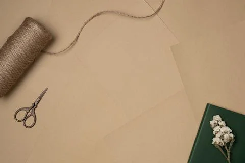 Mockup in vintage style with string, scissors and flower on sheets of paper.. Stock Photos