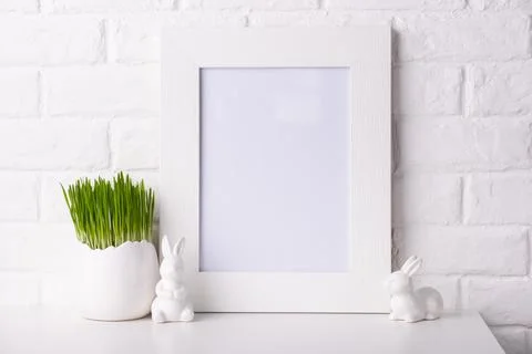Mockup with a white frame and easter decor. 스톡 사진