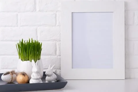 Mockup with a white frame and easter decor. Stock Photos