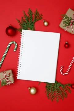 Mockup of white notebook surrounded by thuja branches and wrapped Christmas g Stock Photos