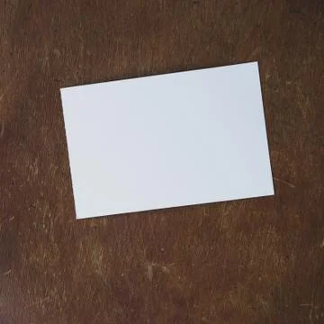 Mockup with white sheet of paper layout on old wooden table. Stock Photos