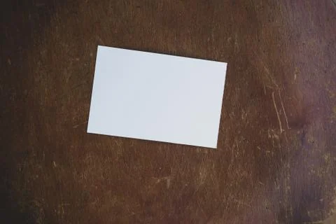 Mockup with white sheet of paper layout on old wooden table. Stock Photos