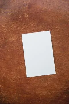 Mockup with white sheet of paper layout on old wooden table. Stock Photos