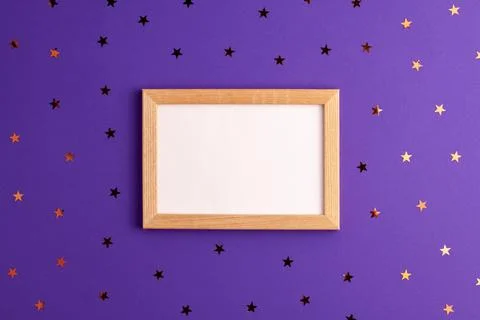Mockup wooden frame with white paper inside and stars around on vibrant Stock Photos