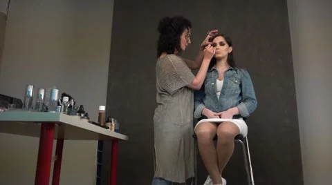 Model and make-up artist for a close-up bottom. Stock Footage 64643735