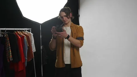 Model and production team in the studio. Male professional photographer holding Stock Footage 263238920