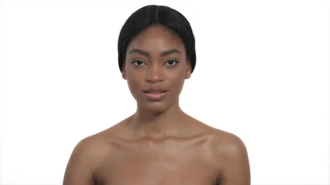 Model applying body lotion. Close-up of an African woman applying moisturizer Stock Footage 131420051