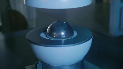 Model of atom in section on background of a powerful, old-style metal reactors  Stock Footage 323932505