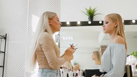 The model is being prepared for the podium. A makeup artist stylist paints a Stock Footage 149247091