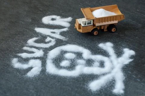 Model of big mining dump-body truck with skull of white sugar Stock Photos