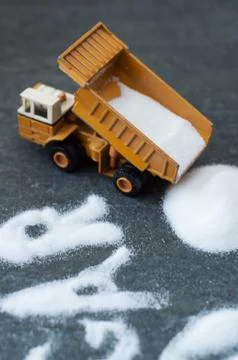 Model of big mining dump-body truck with skull of white sugar Stock Photos