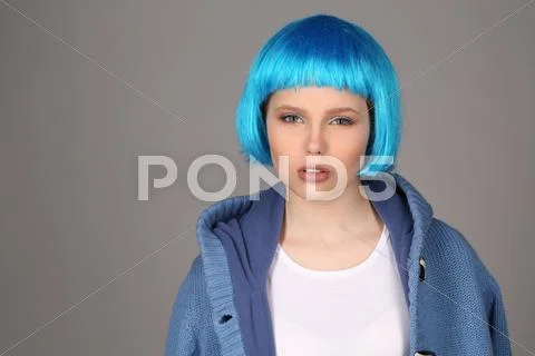 Model In Blue Wig And Coat. Close Up. Gray Background
