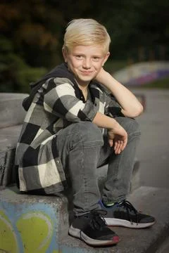 Model boy trying various poses for portrait photos in skate park Stock Photos