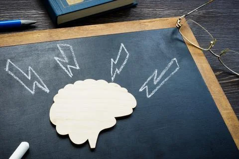 Model of brain and arrows as stroke or emotional pressure. Stock Photos