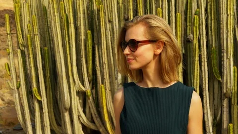 Model with Cacti in Background Lip Biting and Waving at Someone Video stock 114172608