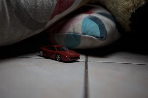 Model car next to pillows Stock Photos