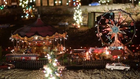 Model carousel and ferris wheel lit with Christmas lights Stock Footage 83627298