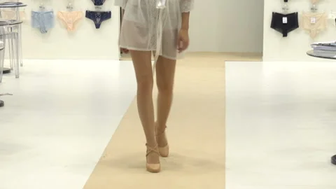 Model on the catwalk demonstrates a white transparent dress Video stock 134594049