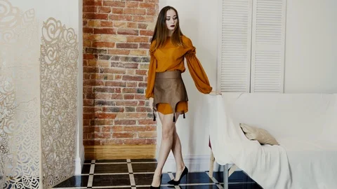 Model changes her poses in the studio, girl in trendy clothes with fashionable Stock Footage 93542070