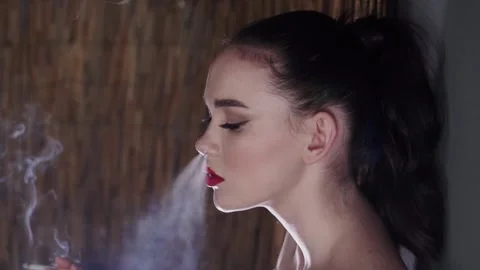 Model With Cigarette In the Studio Stock Footage 154094350