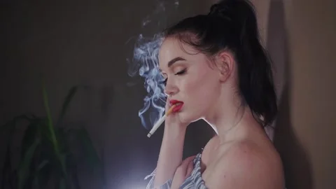 Model With Cigarette In the Studio Stock Footage 154094369