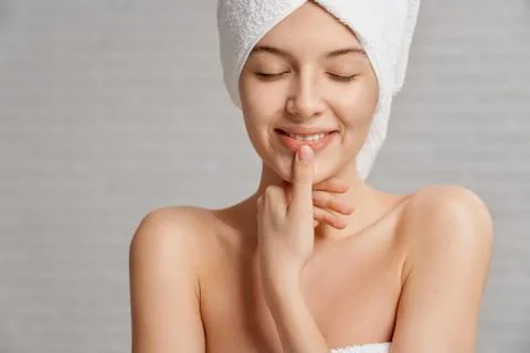Model with clean skin touching lips, posing. Stock Photos